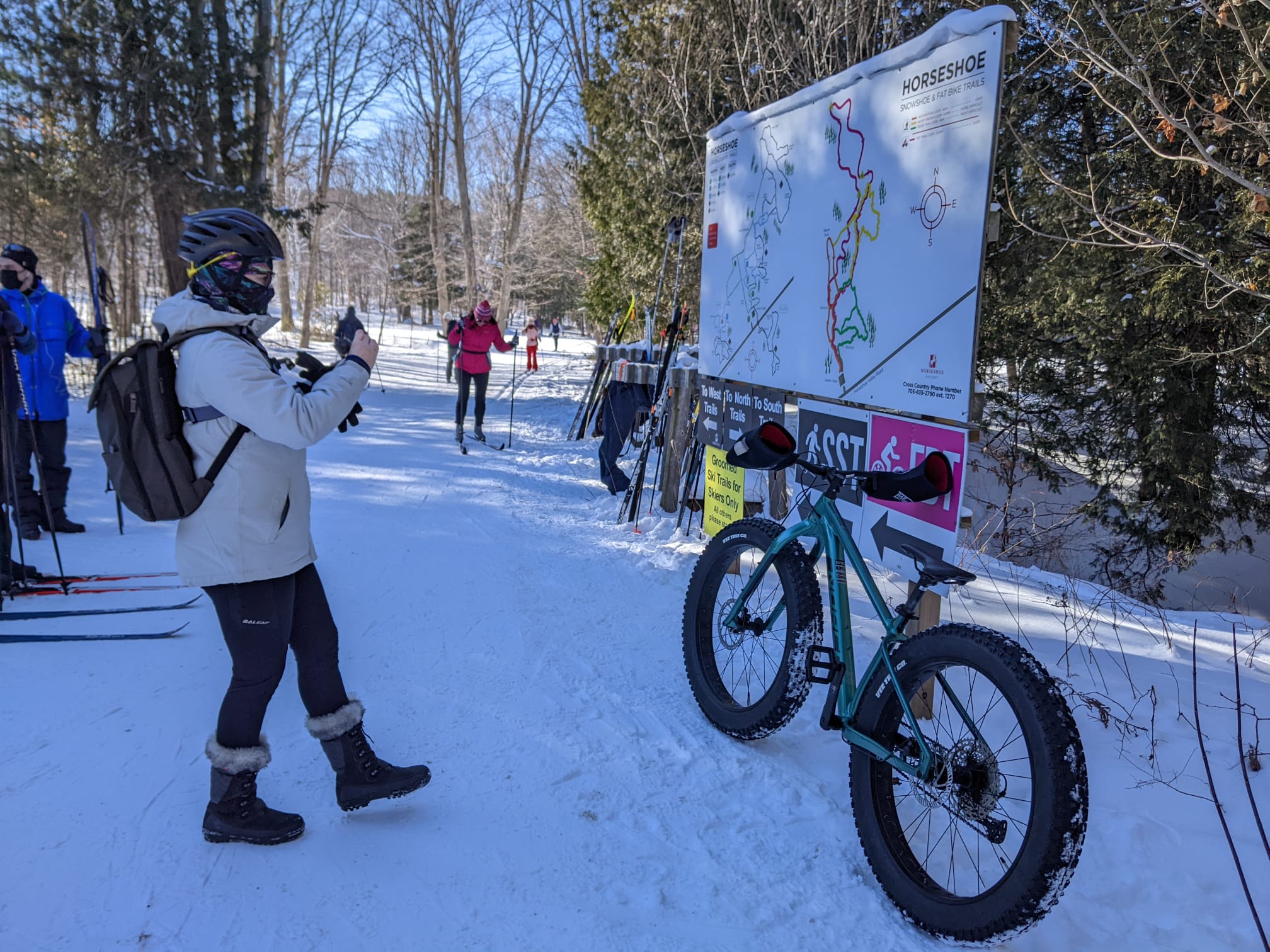 Agnieszka is holding an action camera and is filming the Horseshoe Valley fat biking trail map